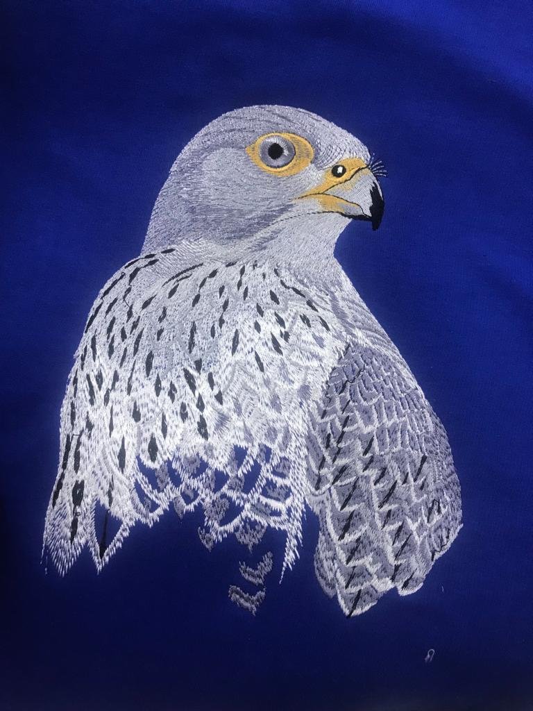 Embroidered falcon in white and grey thread