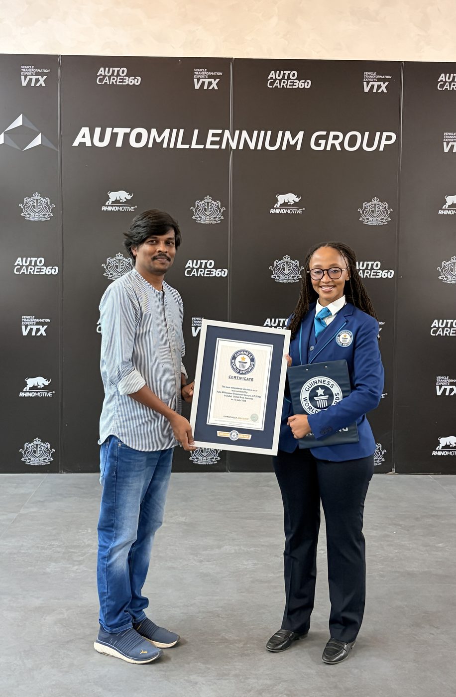 Receiving the Guinness World Records certificate from the adjudicator, Auto Millennium Group, Dubai