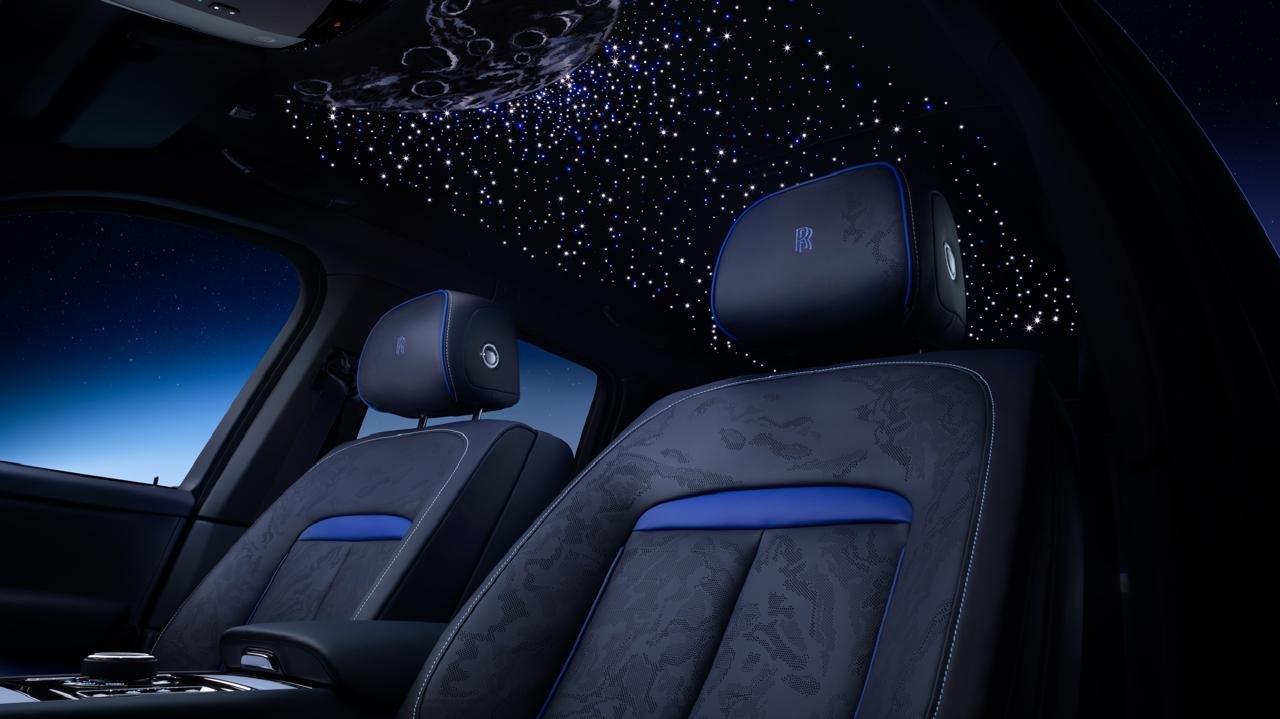 Dark cabin with embroidered starlight headliner and blue-accented seats
