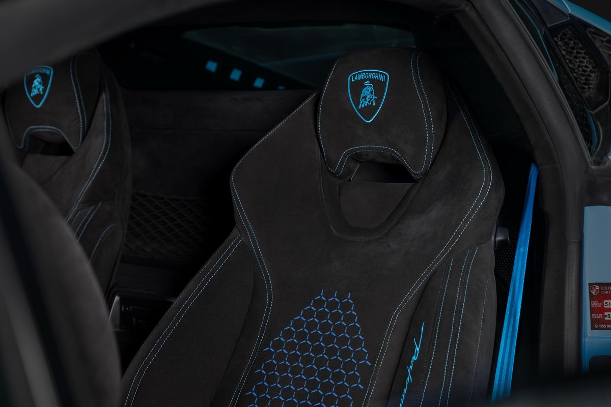 Seat with laser-engraved pattern and headrest emblem