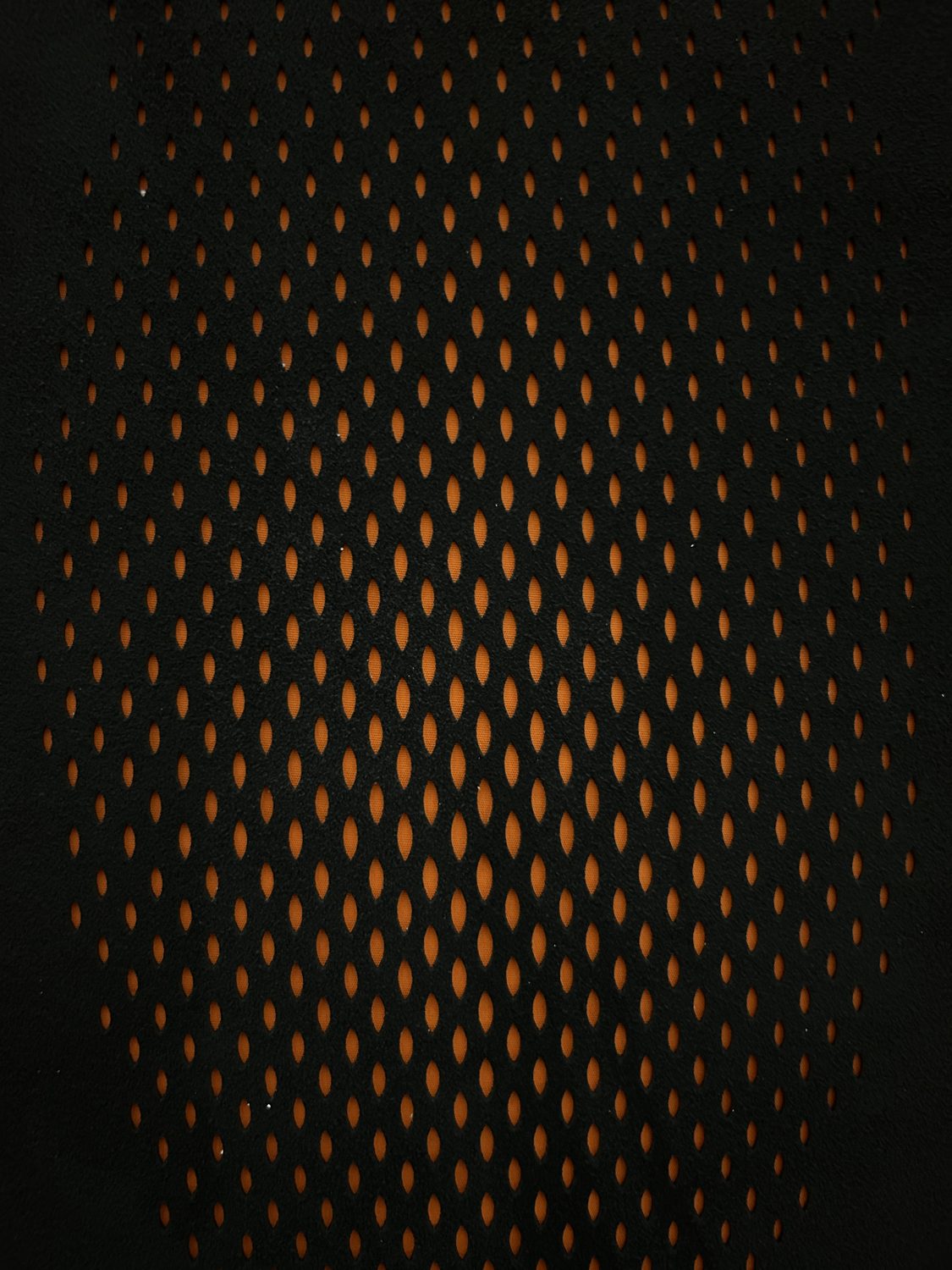 Laser-perforated pattern lit from behind