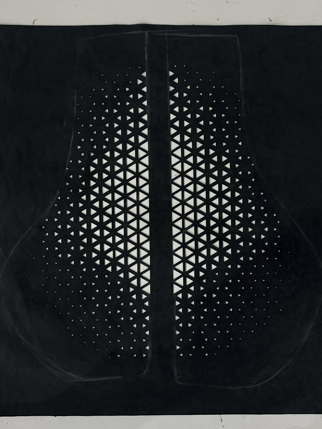 Triangle perforation pattern on a black panel