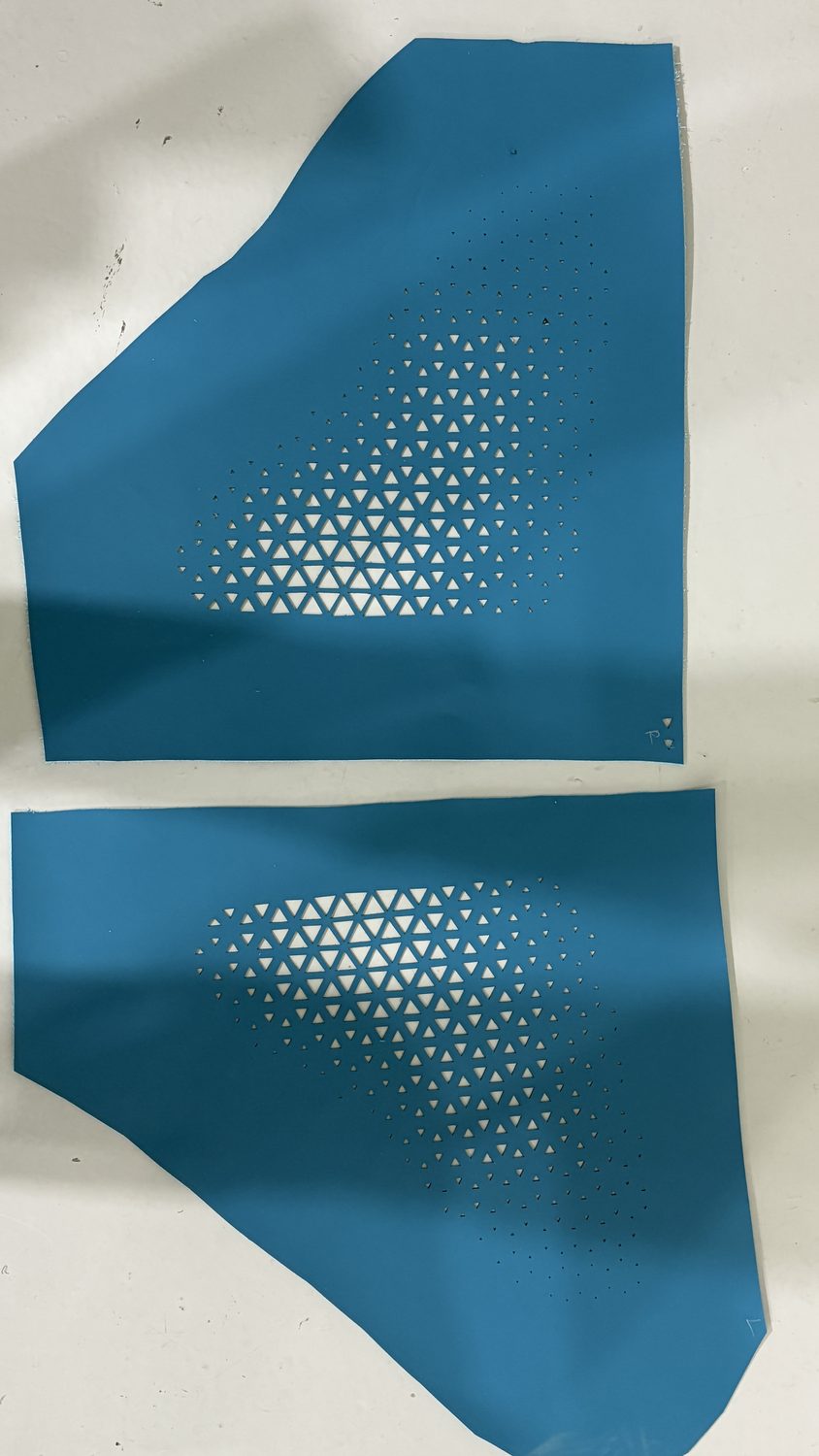 Gradient perforation pattern on teal leather panels