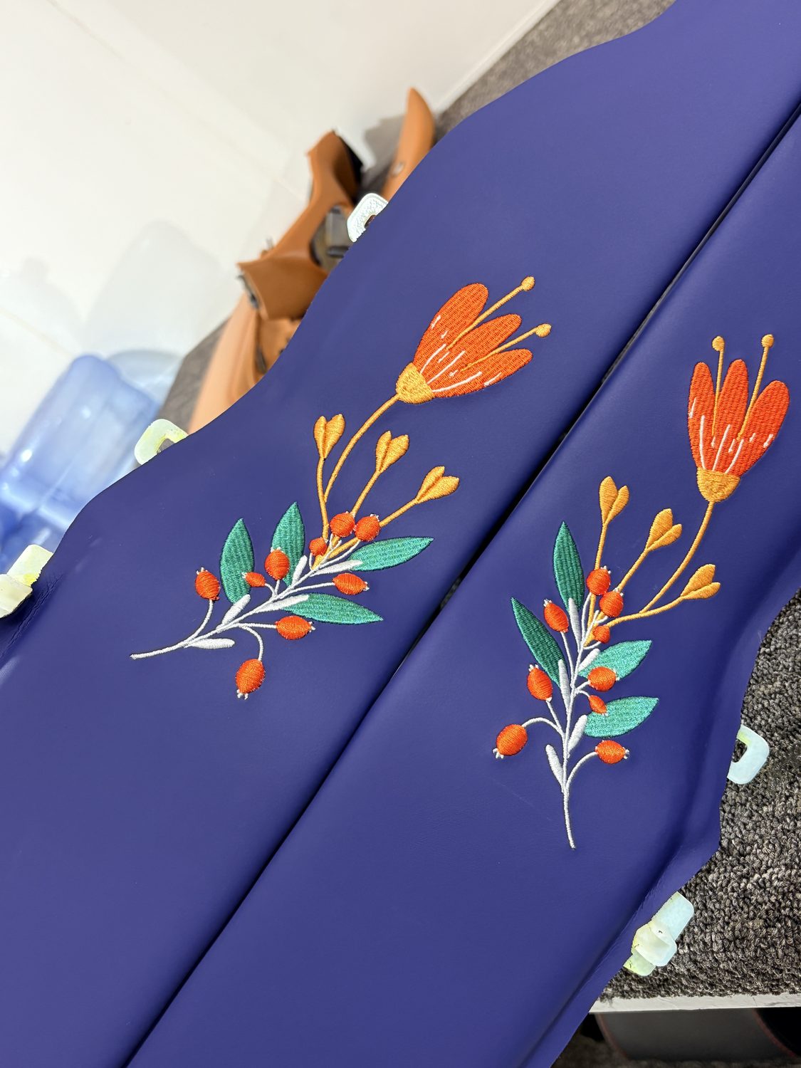 Floral embroidery on blue panels
