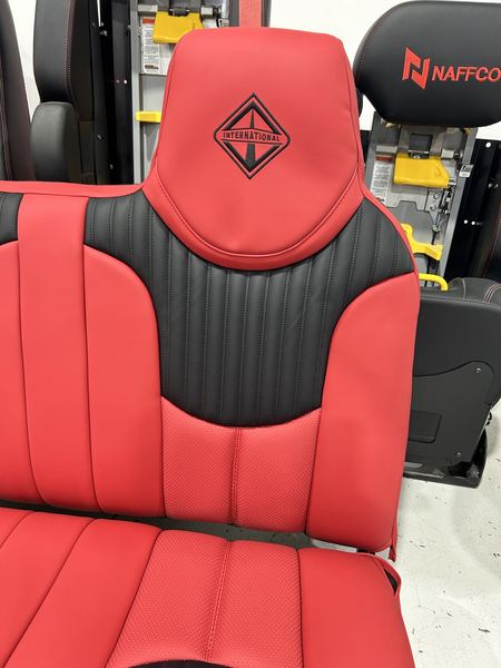Red and black seat with embroidered headrest emblem