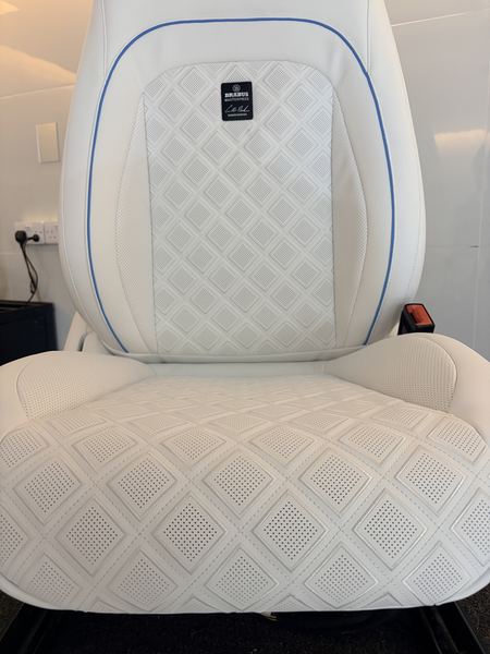 White seat with diamond quilting and badge