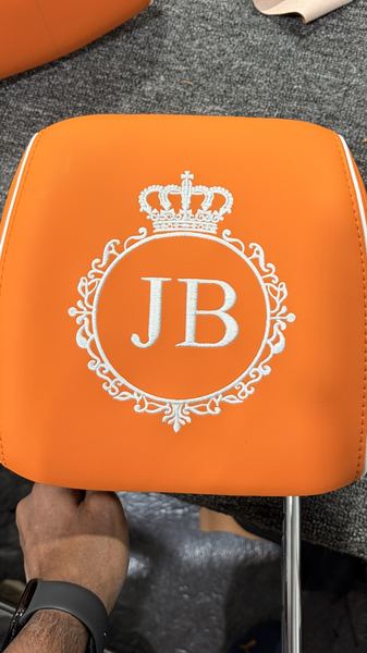 JB crown monogram embroidered on an orange headrest