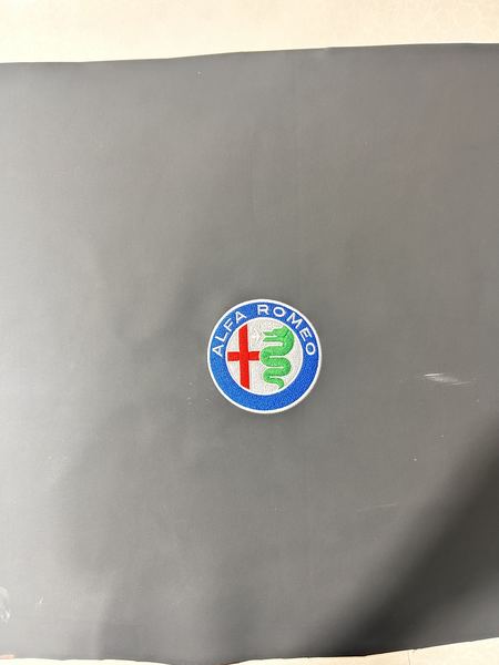 Alfa Romeo badge on grey leather