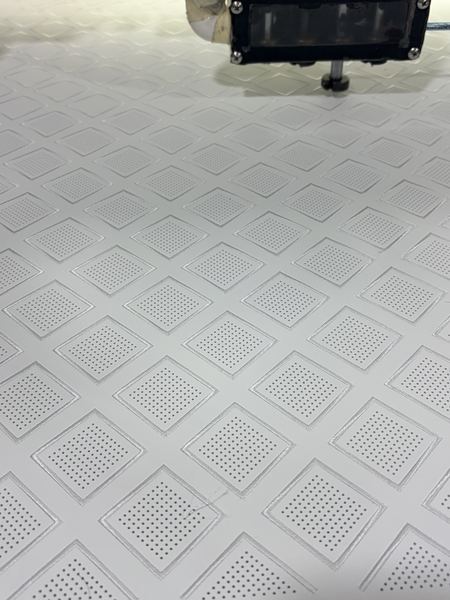 Perforated diamond pattern on white leather