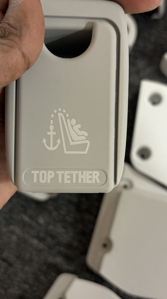 Top Tether trim cover, laser-etched symbol